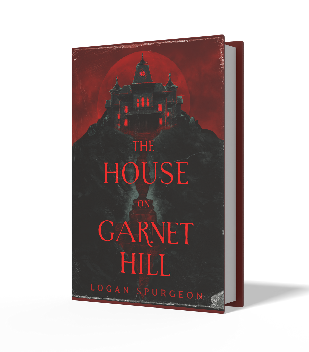 A book titled 'The House on Garnet Hill' by Logan Spurgeon, shown standing upright at a slight angle on a white background. The cover features a dark gothic house silhouette against a red sky with a red full moon, and the title is written in red text.